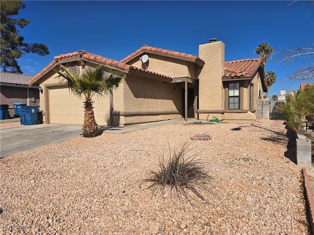 mediterranean / spanish home with a garage