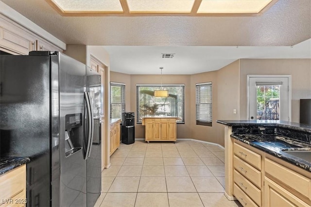 kitchen with light brown cabinetry, stainless steel fridge with ice dispenser, decorative light fixtures, and light tile patterned flooring