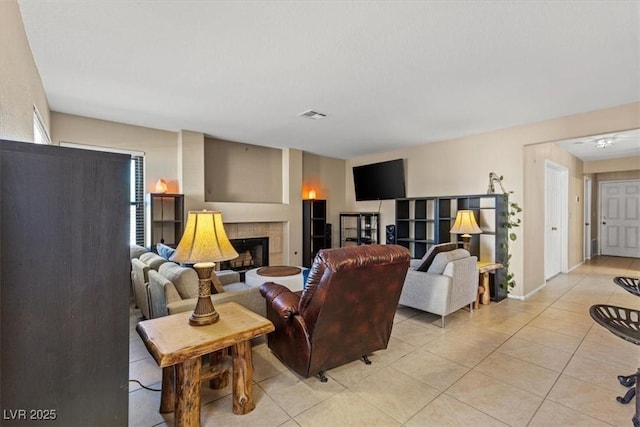 tiled living room with a tile fireplace