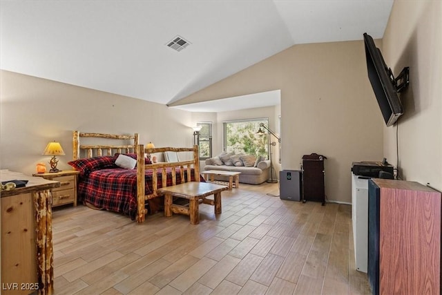 bedroom featuring vaulted ceiling and light wood-type flooring