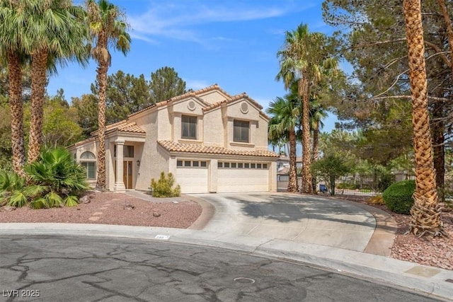 mediterranean / spanish house with a garage