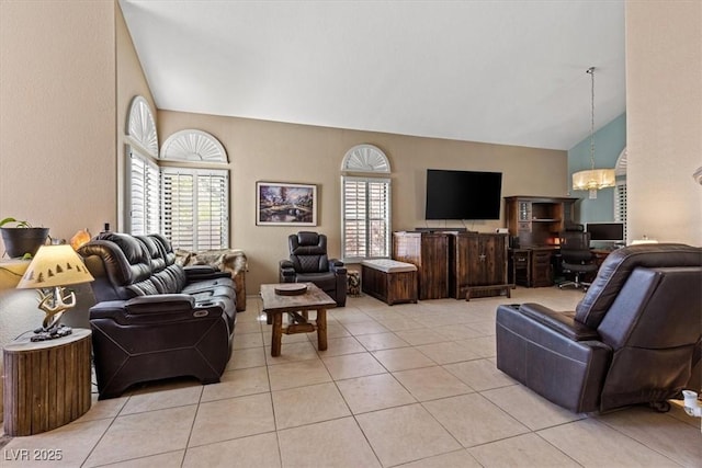 living room with an inviting chandelier, high vaulted ceiling, and light tile patterned floors