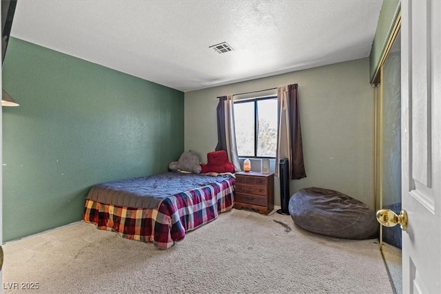 bedroom featuring carpet flooring and a textured ceiling