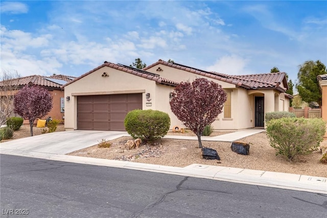 mediterranean / spanish-style home with a tiled roof, stucco siding, driveway, and a garage