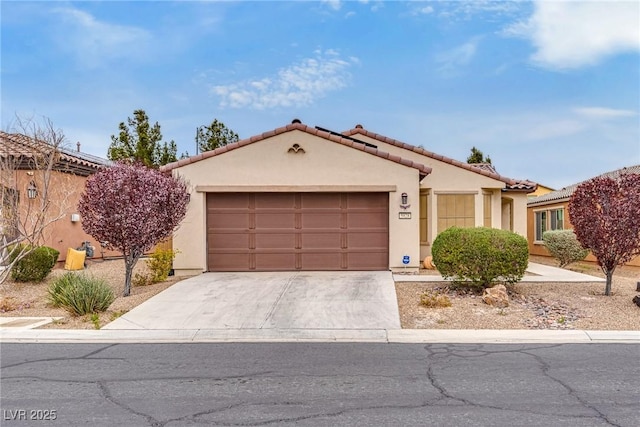 mediterranean / spanish-style home with a tiled roof, stucco siding, driveway, and a garage