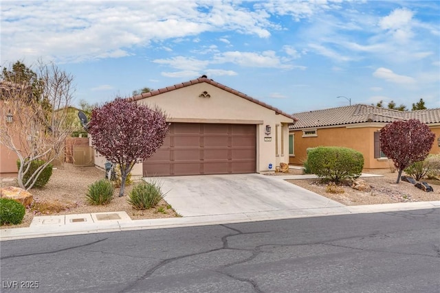 mediterranean / spanish home with stucco siding, a tile roof, fence, concrete driveway, and a garage