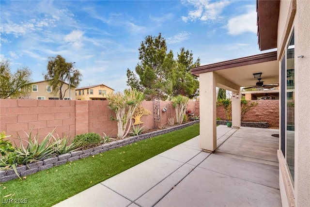 view of patio with a fenced backyard and ceiling fan