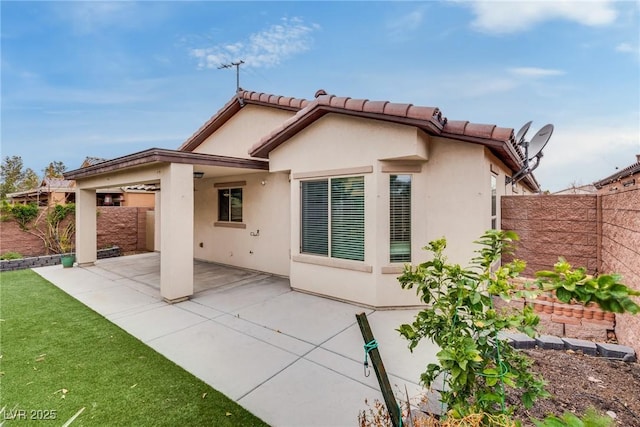 rear view of property with a patio area, a fenced backyard, and stucco siding