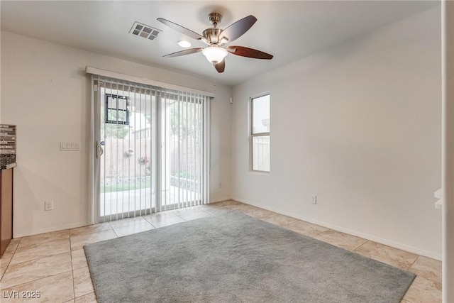 spare room with visible vents, baseboards, ceiling fan, and light tile patterned flooring