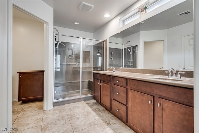 bathroom with a shower stall, visible vents, and a sink