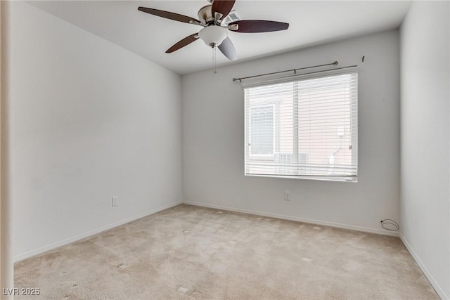 unfurnished room with light colored carpet, baseboards, and ceiling fan