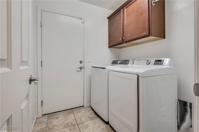 washroom featuring light tile patterned floors, cabinet space, and separate washer and dryer