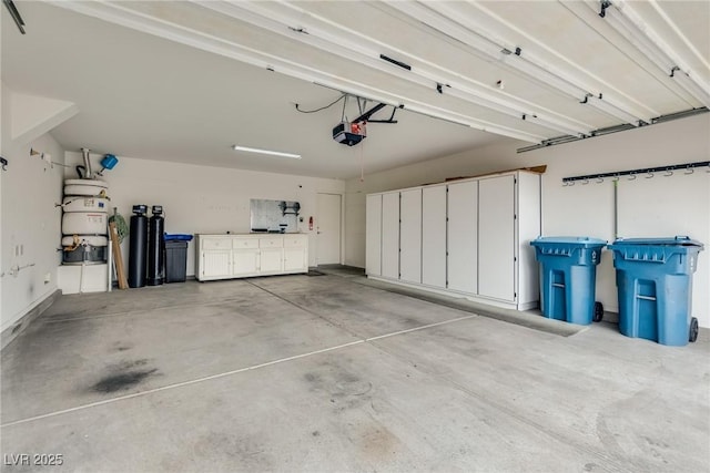 garage featuring secured water heater and a garage door opener