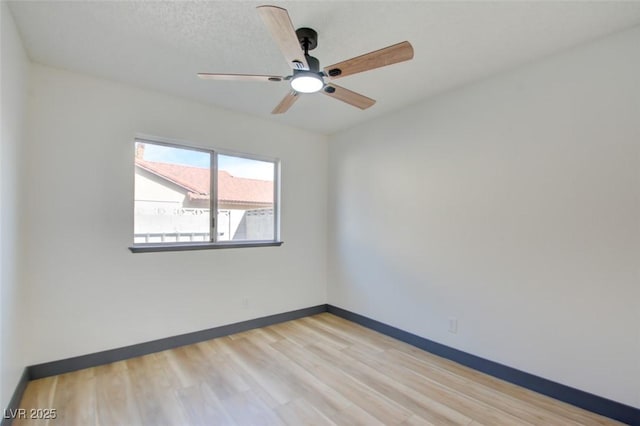 unfurnished room with ceiling fan and light hardwood / wood-style floors