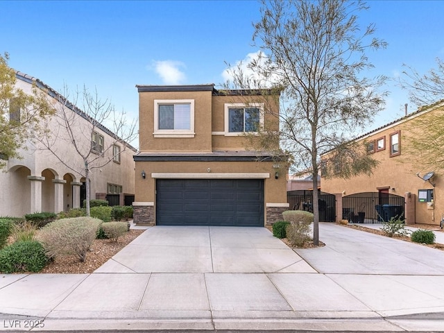 view of front facade with stone siding, concrete driveway, and stucco siding