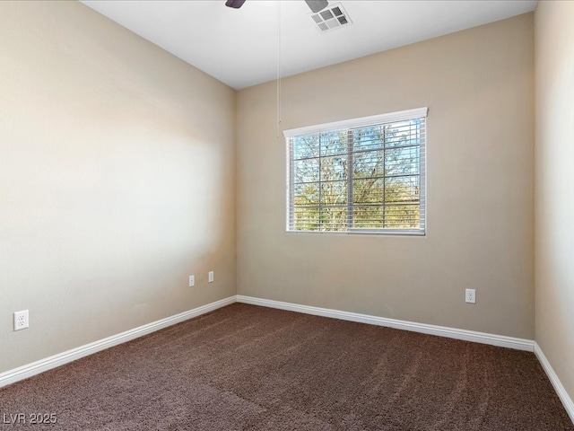 unfurnished room featuring dark colored carpet, a ceiling fan, visible vents, and baseboards