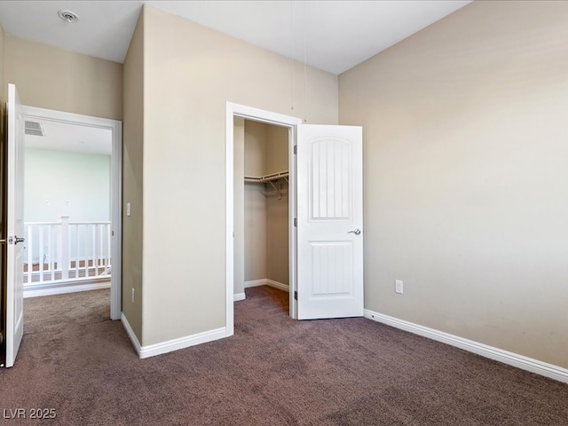 unfurnished bedroom with carpet, visible vents, and baseboards