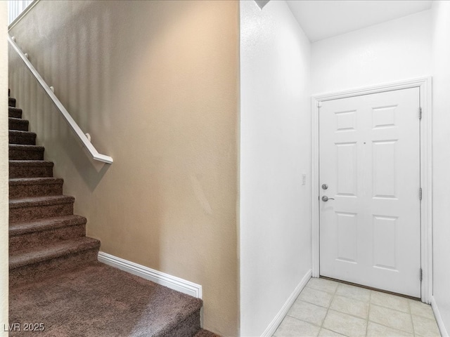 entryway featuring stairway and baseboards