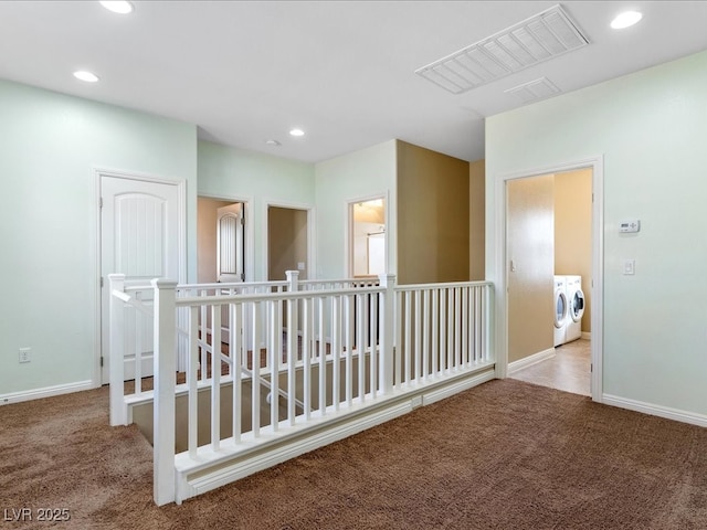 hallway featuring carpet, visible vents, independent washer and dryer, and an upstairs landing