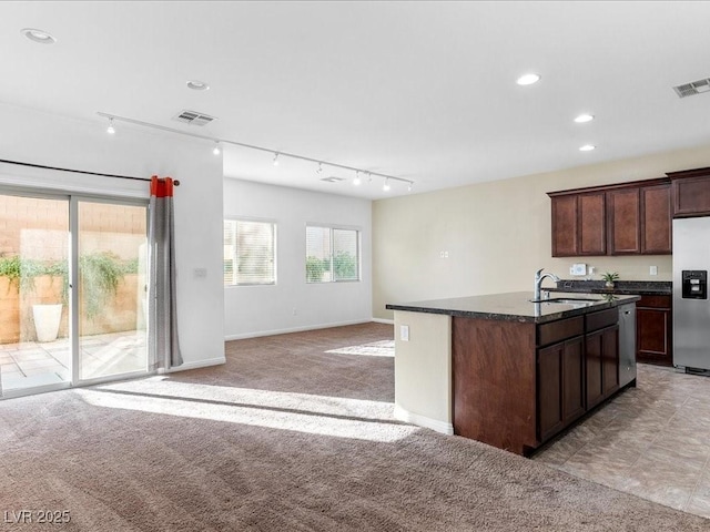 kitchen with light carpet, visible vents, appliances with stainless steel finishes, rail lighting, and a sink