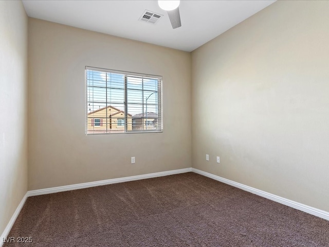 carpeted empty room with baseboards, visible vents, and ceiling fan