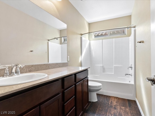 full bath featuring vanity, tub / shower combination, wood finished floors, and toilet