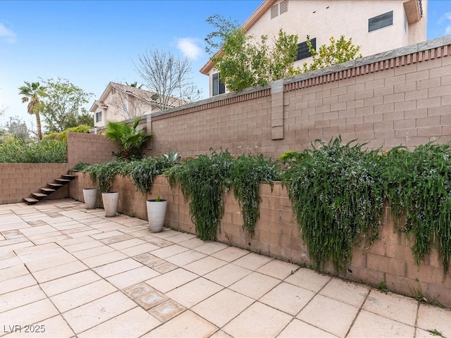 view of patio / terrace featuring a fenced backyard and stairway