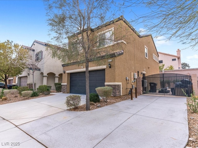 view of front of property featuring driveway, stone siding, a gate, and stucco siding