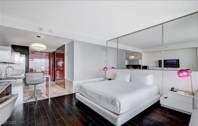 4381 W Flamingo Rd Unit 3007, Las Vegas, NV 89103 - bedroom featuring wood finished floors and a sink