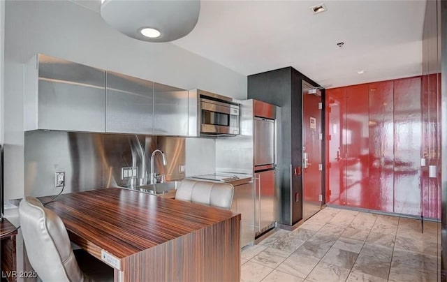 4381 W Flamingo Rd Unit 3007, Las Vegas, NV 89103 - kitchen featuring appliances with stainless steel finishes, marble finish floor, a sink, and visible vents