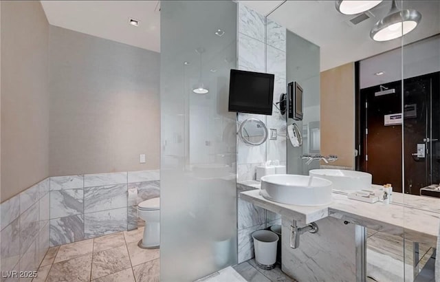 4381 W Flamingo Rd Unit 3007, Las Vegas, NV 89103 - full bathroom with a sink, visible vents, tile walls, and toilet