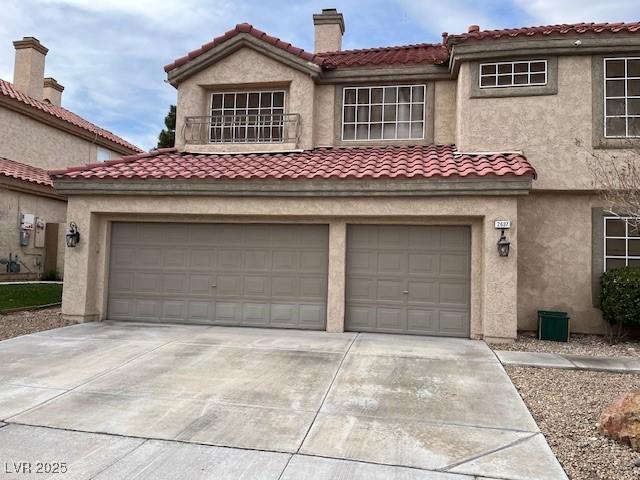 mediterranean / spanish house with a garage