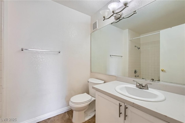 bathroom with tile patterned flooring, vanity, a chandelier, and toilet