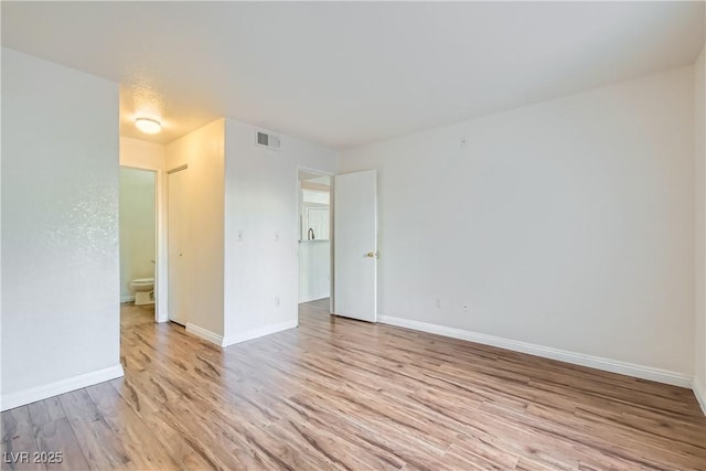 spare room with light hardwood / wood-style floors