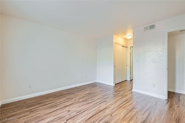 spare room featuring light hardwood / wood-style flooring