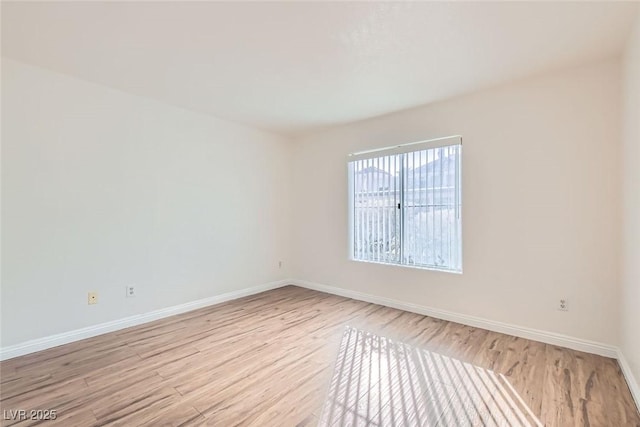 spare room featuring light wood-type flooring