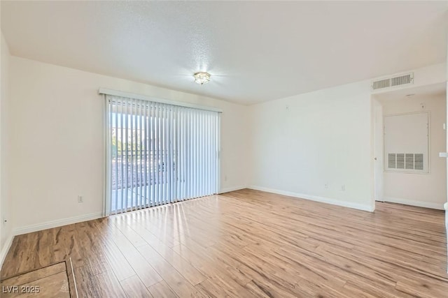 unfurnished room with light wood-type flooring