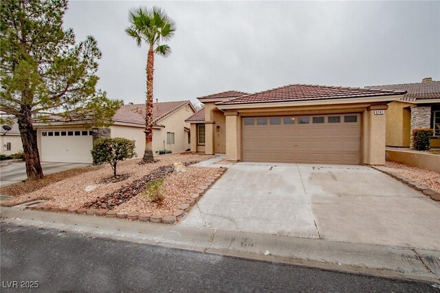 view of front of property featuring stucco siding, a garage, concrete driveway, and a tile roof