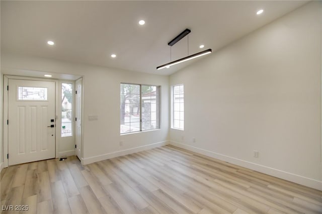 foyer with recessed lighting, baseboards, and light wood-style floors