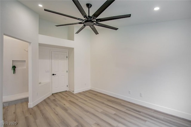 empty room with recessed lighting, baseboards, light wood-type flooring, and ceiling fan