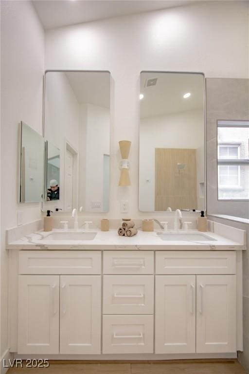 full bath featuring double vanity and a sink