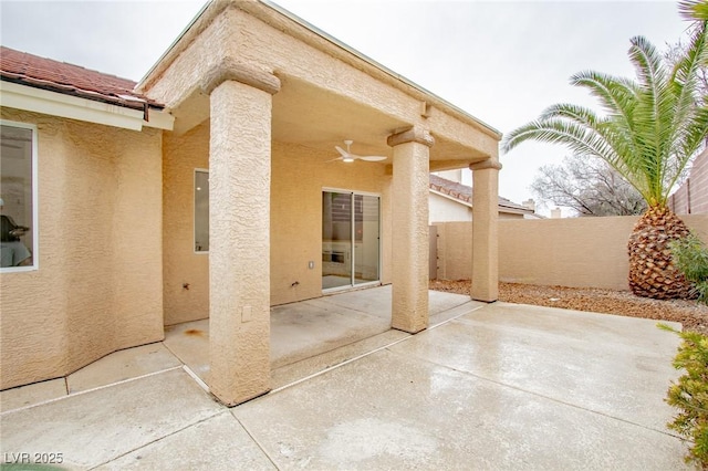 view of patio with a ceiling fan and fence