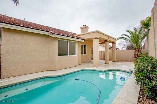 view of pool featuring a patio area and fence