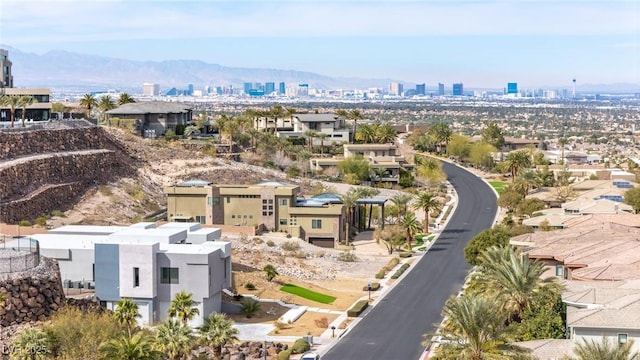 drone / aerial view featuring a city view and a mountain view