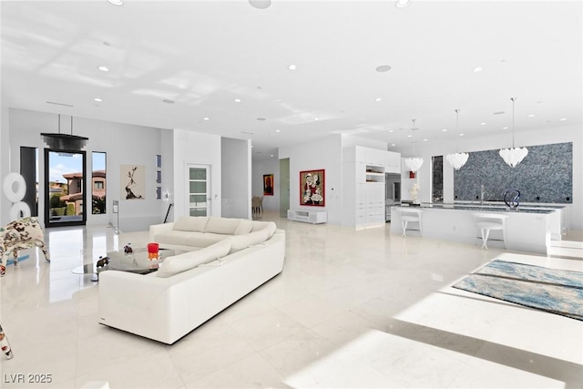 living room featuring recessed lighting and marble finish floor