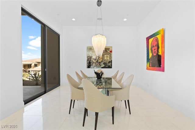 dining area with recessed lighting and an inviting chandelier