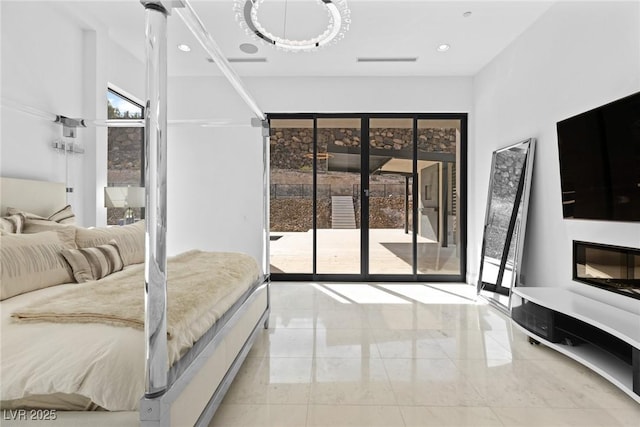 bedroom featuring marble finish floor, recessed lighting, a glass covered fireplace, and access to exterior