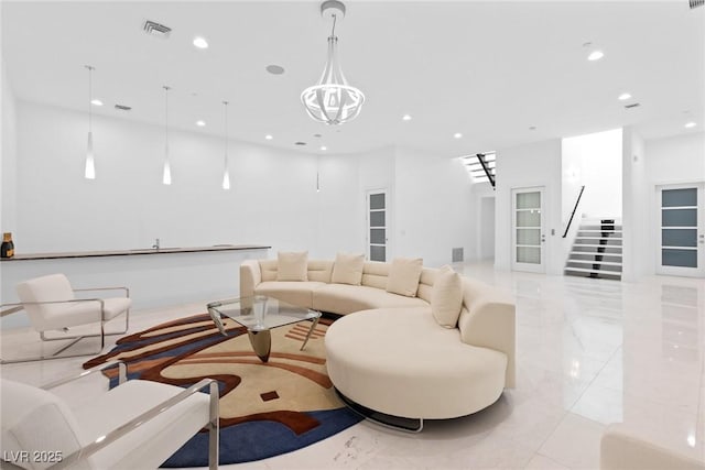 living room featuring a notable chandelier, recessed lighting, visible vents, marble finish floor, and stairway