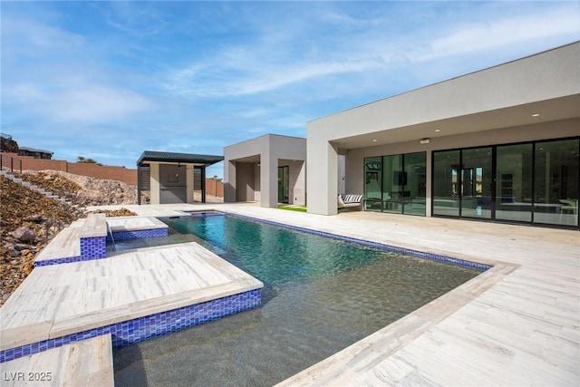 view of swimming pool with a fenced in pool, a patio area, and a hot tub