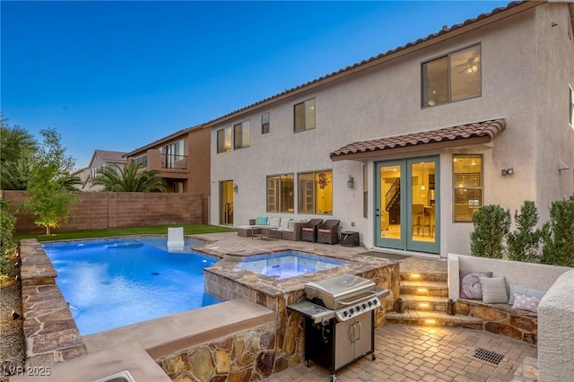 view of swimming pool featuring an in ground hot tub, area for grilling, a patio area, and french doors